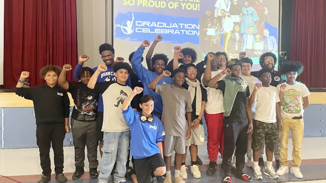 IYT brothers gather in front of families for a final group photo.