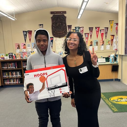 King Jermaine Newman, a 6th grader, is posing with his prize he won for Academic Achievement.